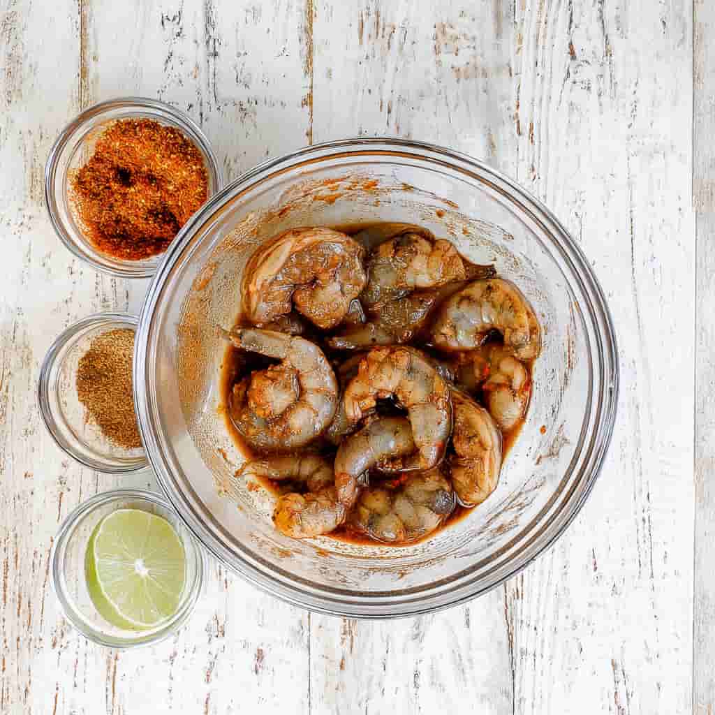  Shrimp cooking in skillet with jerk seasoning