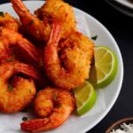 Plated coconut shrimp appetizer with sauces